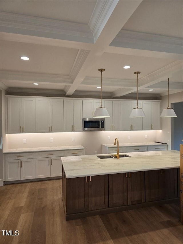 3501 Wesley Point Dr, Browns Summit, NC 27214 - kitchen featuring stainless steel microwave, beam ceiling, white cabinetry, crown molding, and dark wood finished floors