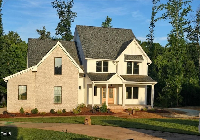 3501 Wesley Point Dr, Browns Summit, NC 27214 - modern inspired farmhouse with a porch, board and batten siding, and a front lawn