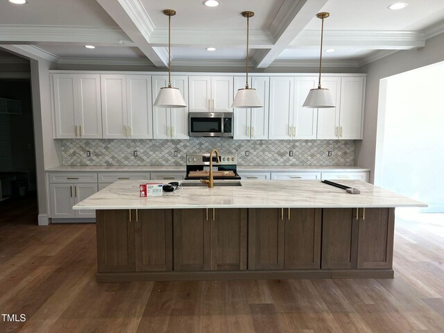 3501 Wesley Point Dr, Browns Summit, NC 27214 - kitchen with stainless steel appliances, beam ceiling, wood finished floors, white cabinets, and crown molding