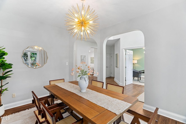 2800 Becketts Ridge Dr, Hillsborough, NC 27278 - dining room featuring arched walkways, a chandelier, and wood finished floors