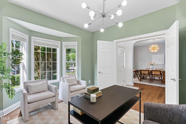 2800 Becketts Ridge Dr, Hillsborough, NC 27278 - living area with arched walkways, healthy amount of natural light, light wood-type flooring, and a chandelier