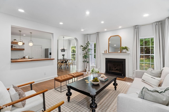 2800 Becketts Ridge Dr, Hillsborough, NC 27278 - living area with arched walkways, wood finished floors, plenty of natural light, recessed lighting, and a fireplace