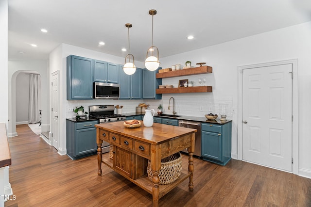 2800 Becketts Ridge Dr, Hillsborough, NC 27278 - kitchen featuring stainless steel appliances, blue cabinets, arched walkways, open shelves, and decorative backsplash