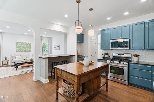 2800 Becketts Ridge Dr, Hillsborough, NC 27278 - kitchen with appliances with stainless steel finishes, blue cabinetry, backsplash, dark wood-style flooring, and recessed lighting