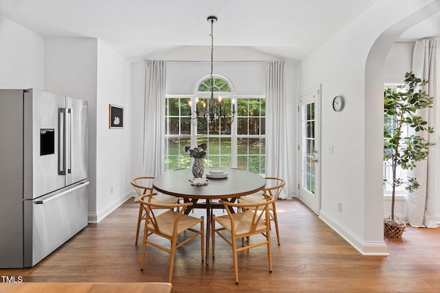 2800 Becketts Ridge Dr, Hillsborough, NC 27278 - dining room with arched walkways, wood finished floors, vaulted ceiling, and a chandelier