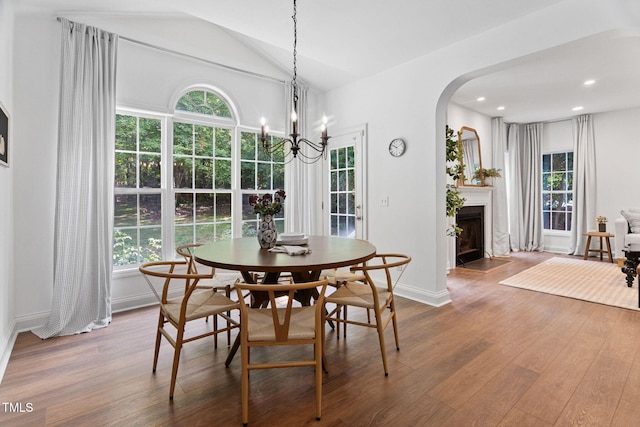 2800 Becketts Ridge Dr, Hillsborough, NC 27278 - dining room featuring arched walkways, wood finished floors, a fireplace with flush hearth, vaulted ceiling, and recessed lighting