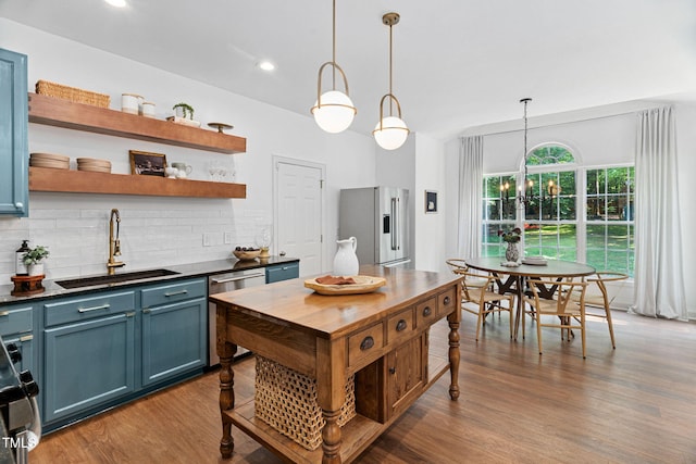 2800 Becketts Ridge Dr, Hillsborough, NC 27278 - kitchen featuring stainless steel appliances, backsplash, dark wood-type flooring, blue cabinetry, and pendant lighting