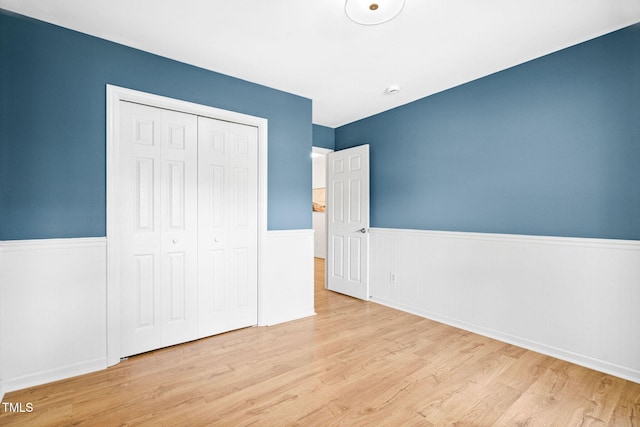 2800 Becketts Ridge Dr, Hillsborough, NC 27278 - unfurnished bedroom with wood finished floors, a wainscoted wall, and a closet