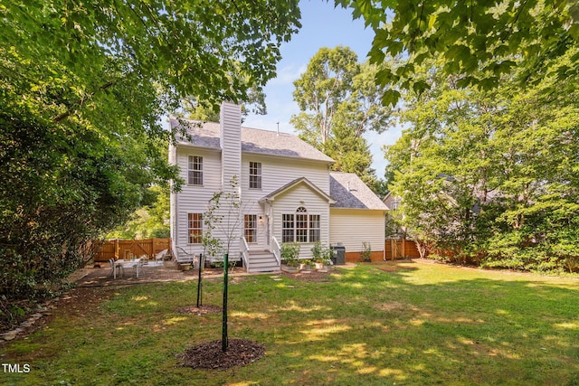 2800 Becketts Ridge Dr, Hillsborough, NC 27278 - rear view of house featuring a fenced backyard, a chimney, a shingled roof, and a patio