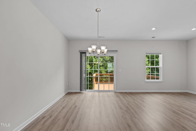 1119 Platform Dr, Apex, NC 27502 - spare room with wood finished floors, a chandelier, and recessed lighting