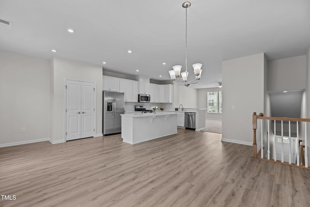 1119 Platform Dr, Apex, NC 27502 - kitchen with appliances with stainless steel finishes, open floor plan, a chandelier, a center island, and light countertops