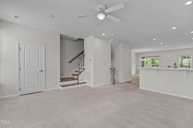 1119 Platform Dr, Apex, NC 27502 - unfurnished living room featuring light carpet, a ceiling fan, and recessed lighting