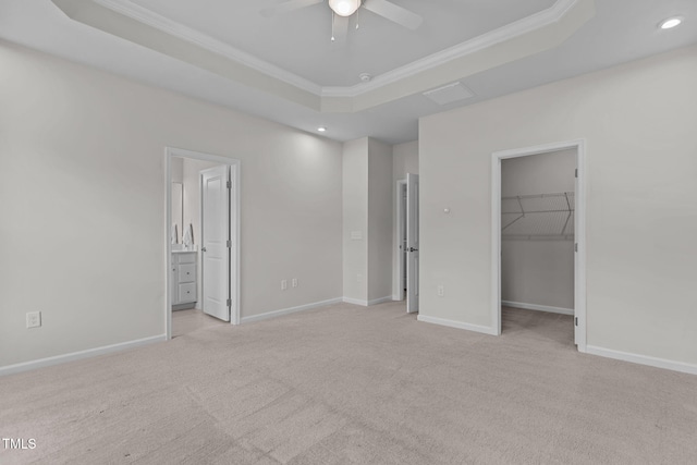 1119 Platform Dr, Apex, NC 27502 - unfurnished bedroom with a tray ceiling, ornamental molding, recessed lighting, carpet, and a spacious closet