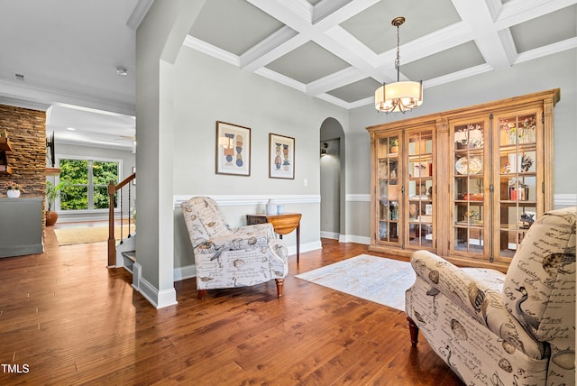3313 Bentwinds Bluffs Ln, Fuquay Varina, NC 27526 - sitting room featuring arched walkways, a chandelier, wood-type flooring, stairway, and beam ceiling