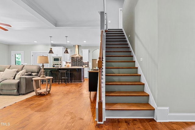 3313 Bentwinds Bluffs Ln, Fuquay Varina, NC 27526 - staircase with ceiling fan, crown molding, wood-type flooring, and recessed lighting