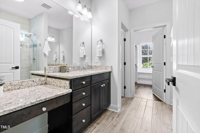 3313 Bentwinds Bluffs Ln, Fuquay Varina, NC 27526 - full bathroom with vanity, a shower stall, and wood finished floors