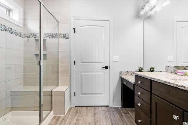 3313 Bentwinds Bluffs Ln, Fuquay Varina, NC 27526 - full bathroom featuring vanity, a stall shower, and wood finished floors