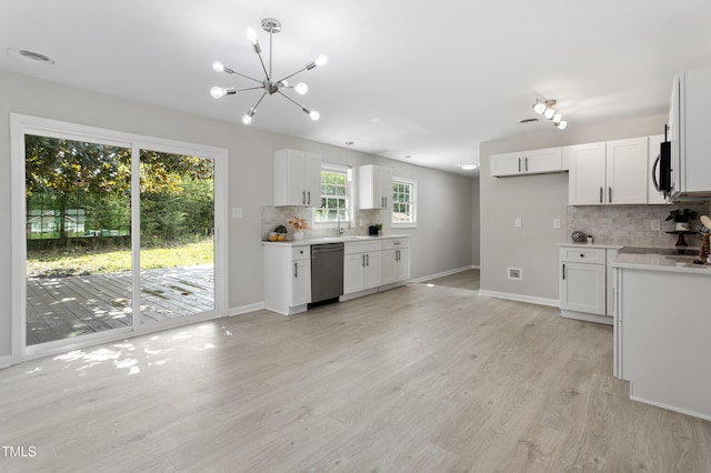 946 Jacksontown Rd, Henderson, NC 27537 - kitchen featuring appliances with stainless steel finishes, backsplash, a chandelier, and light wood finished floors