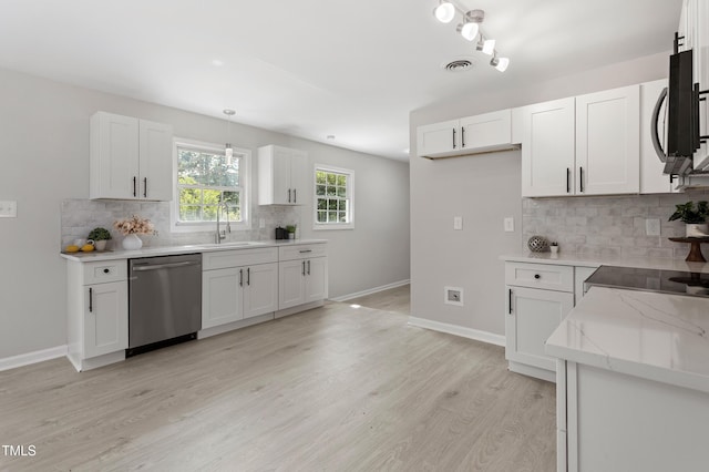 946 Jacksontown Rd, Henderson, NC 27537 - kitchen featuring dishwasher, light stone counters, backsplash, and white cabinetry