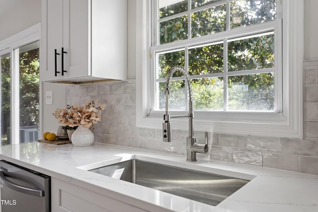 946 Jacksontown Rd, Henderson, NC 27537 - kitchen with white cabinets, tasteful backsplash, light stone counters, and dishwasher