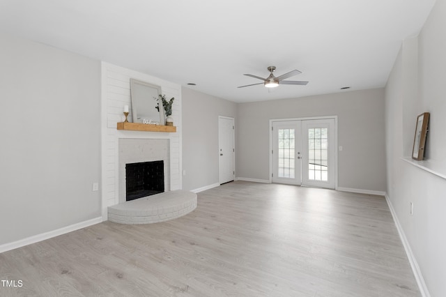 946 Jacksontown Rd, Henderson, NC 27537 - unfurnished living room with light wood-style flooring, a fireplace, ceiling fan, and french doors