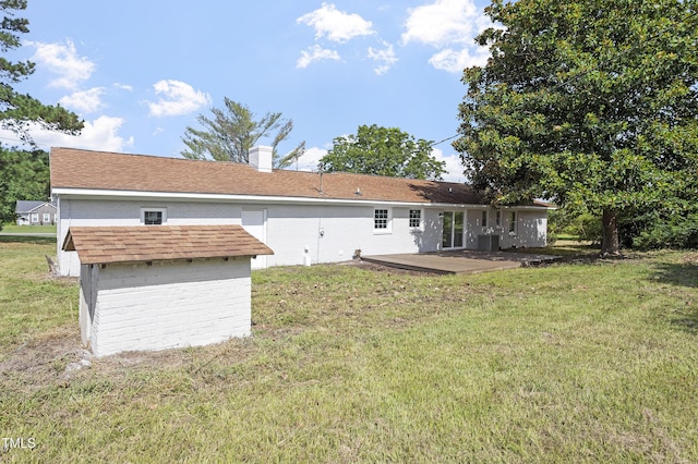 946 Jacksontown Rd, Henderson, NC 27537 - rear view of property featuring a lawn, a chimney, a patio area, and a storage unit