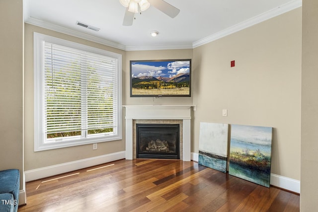 400 W Rosemary St Unit 102, Chapel Hill, NC 27516 - unfurnished living room featuring ornamental molding, a tiled fireplace, a ceiling fan, and wood finished floors