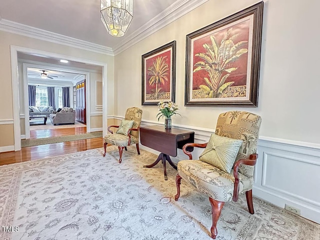 141 Country Club Dr, Henderson, NC 27536 - living area featuring crown molding, wainscoting, wood finished floors, and a decorative wall