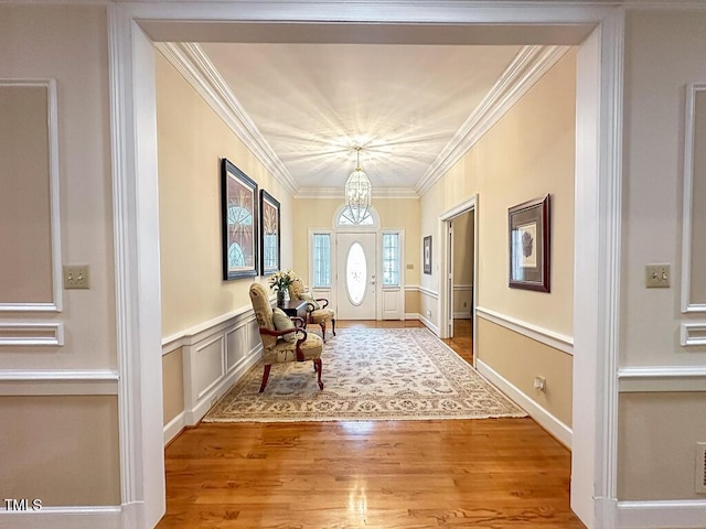141 Country Club Dr, Henderson, NC 27536 - foyer entrance with ornamental molding, a chandelier, and wood finished floors