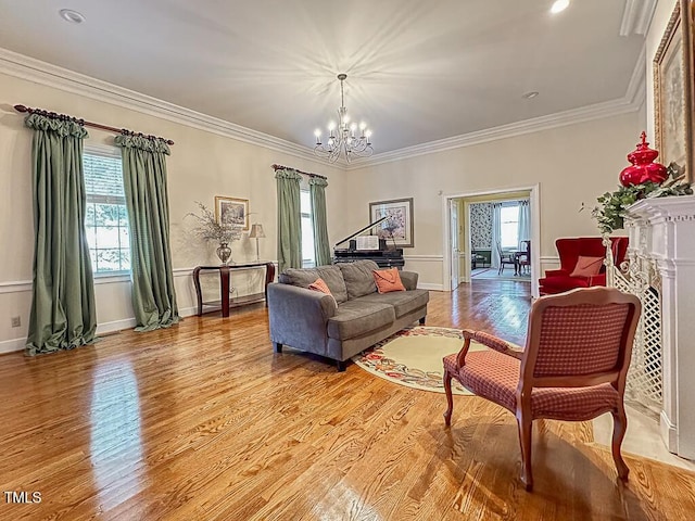 141 Country Club Dr, Henderson, NC 27536 - living room featuring healthy amount of natural light, a chandelier, light wood-style flooring, and crown molding