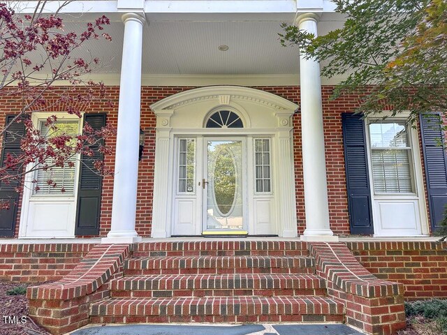 141 Country Club Dr, Henderson, NC 27536 - doorway to property with brick siding and covered porch