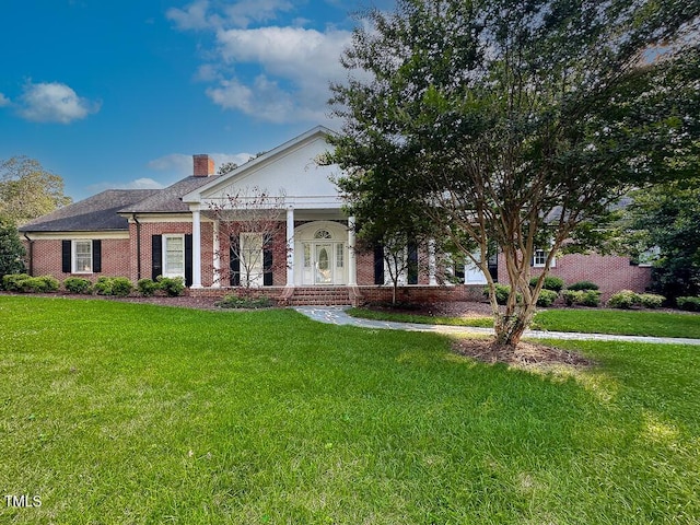 141 Country Club Dr, Henderson, NC 27536 - greek revival inspired property featuring a chimney, a front yard, brick siding, and a porch
