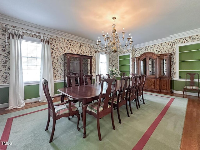 141 Country Club Dr, Henderson, NC 27536 - dining space featuring wallpapered walls, a chandelier, ornamental molding, healthy amount of natural light, and wood finished floors