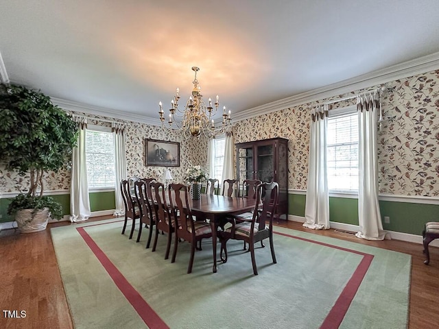 141 Country Club Dr, Henderson, NC 27536 - dining area with wallpapered walls, crown molding, a chandelier, healthy amount of natural light, and wood finished floors