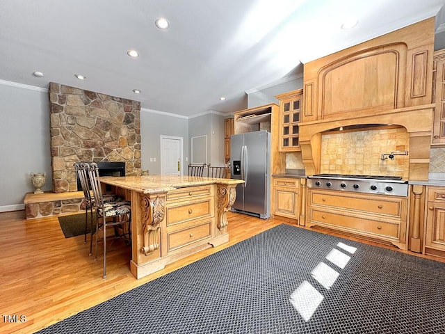 141 Country Club Dr, Henderson, NC 27536 - kitchen featuring stainless steel appliances, ornamental molding, a kitchen bar, light wood finished floors, and backsplash