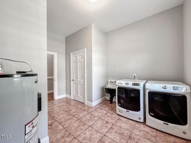 141 Country Club Dr, Henderson, NC 27536 - laundry room with water heater, separate washer and dryer, and light tile patterned floors