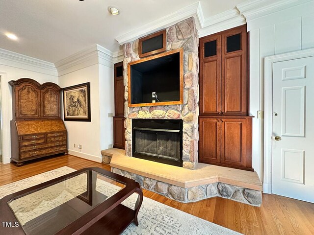 141 Country Club Dr, Henderson, NC 27536 - living room featuring wood finished floors, a stone fireplace, and crown molding