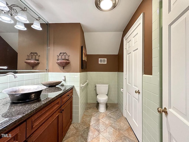141 Country Club Dr, Henderson, NC 27536 - bathroom featuring tile walls, vanity, and a wainscoted wall