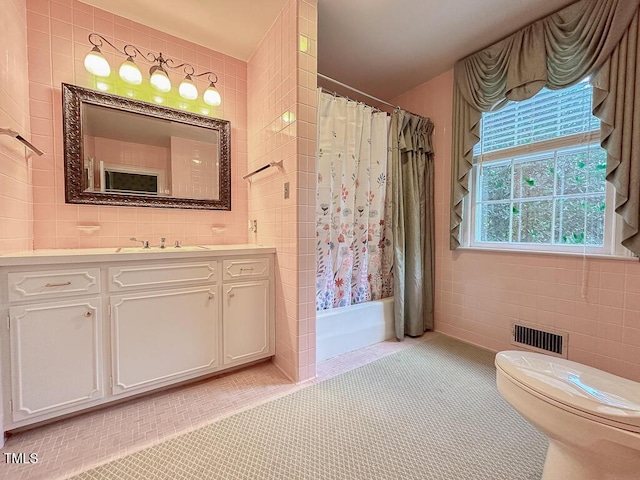 141 Country Club Dr, Henderson, NC 27536 - full bathroom with tile walls, vanity, tile patterned flooring, and shower / bath combo with shower curtain