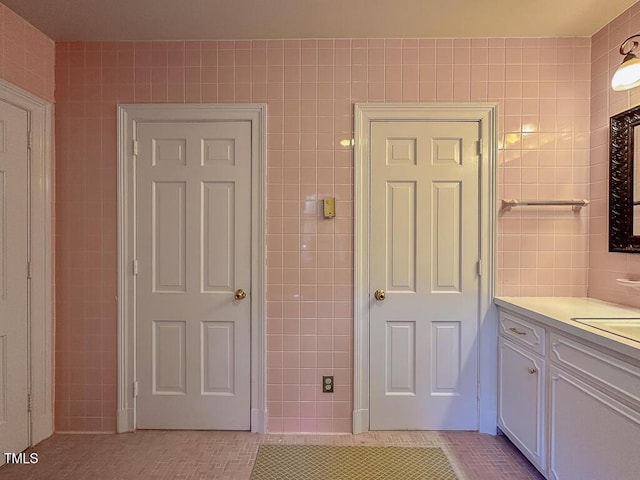 141 Country Club Dr, Henderson, NC 27536 - bathroom with tile walls, vanity, and tile patterned flooring