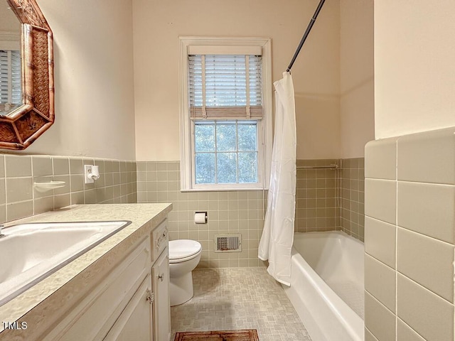 141 Country Club Dr, Henderson, NC 27536 - bathroom with tile walls, healthy amount of natural light, vanity, a wainscoted wall, and tile patterned floors