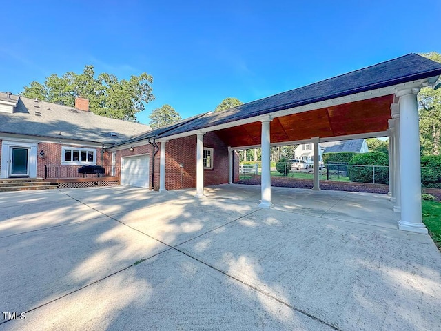 141 Country Club Dr, Henderson, NC 27536 - view of side of property featuring an attached garage, concrete driveway, brick siding, and a chimney
