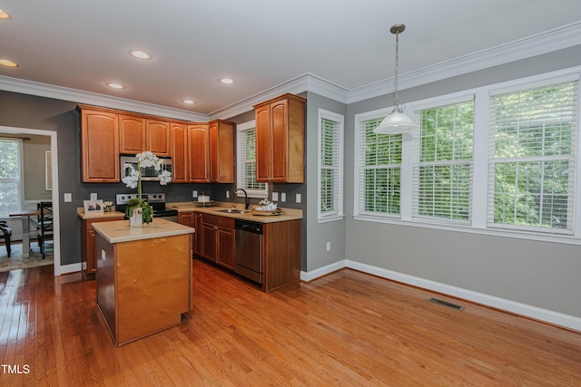 301 Grove Hall Ln, Mebane, NC 27302 - kitchen featuring stainless steel appliances, light countertops, wood finished floors, ornamental molding, and pendant lighting