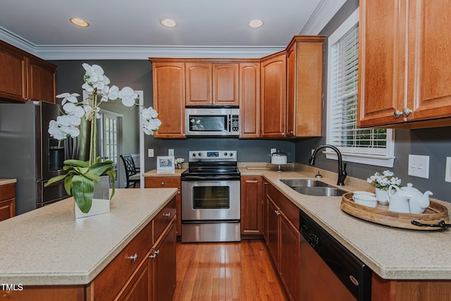 301 Grove Hall Ln, Mebane, NC 27302 - kitchen with appliances with stainless steel finishes, ornamental molding, light countertops, light wood-type flooring, and recessed lighting
