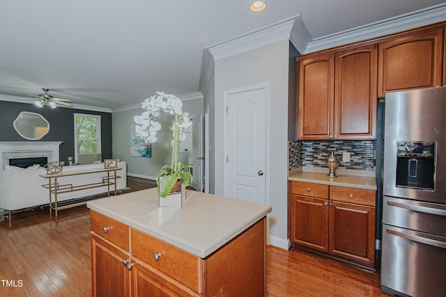 301 Grove Hall Ln, Mebane, NC 27302 - kitchen with stainless steel fridge, ceiling fan, wood finished floors, light countertops, and ornamental molding