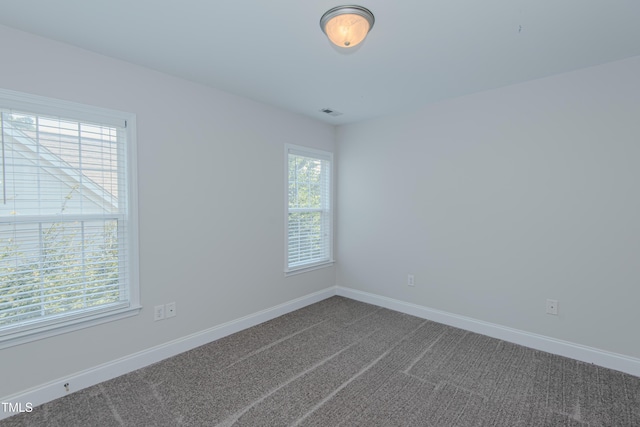 301 Grove Hall Ln, Mebane, NC 27302 - spare room with baseboards and dark colored carpet