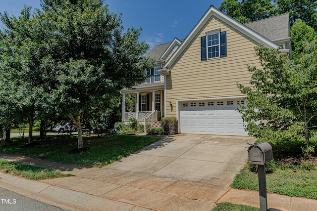 301 Grove Hall Ln, Mebane, NC 27302 - traditional-style house with a garage, a porch, concrete driveway, and roof with shingles