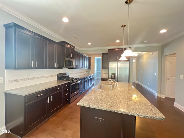 607 Finnbar Dr, Cary, NC 27519 - kitchen featuring stainless steel appliances, backsplash, light stone counters, an island with sink, and ornamental molding