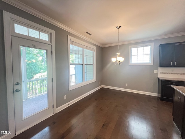 607 Finnbar Dr, Cary, NC 27519 - unfurnished dining area with a chandelier, dark wood-type flooring, and crown molding