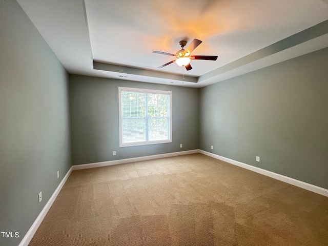 607 Finnbar Dr, Cary, NC 27519 - spare room featuring a tray ceiling, a ceiling fan, and carpet